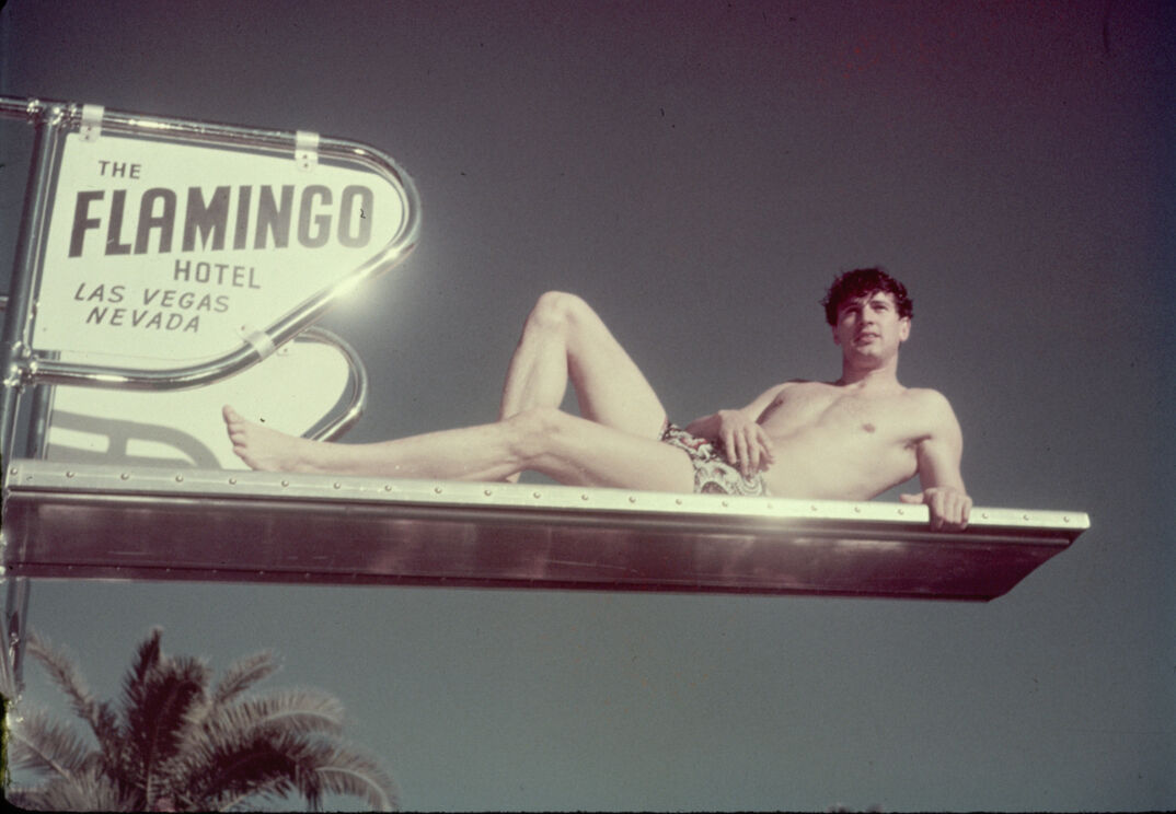 Rock Hudson lounging on a diving board at the Flamingo Hotel in Las Vegas.