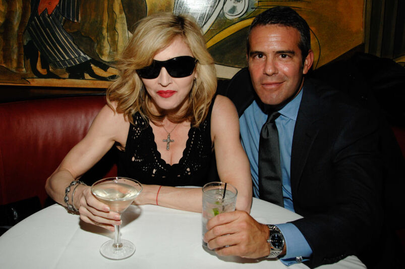 Madonna and Andy Cohen sitting in a restaurant together