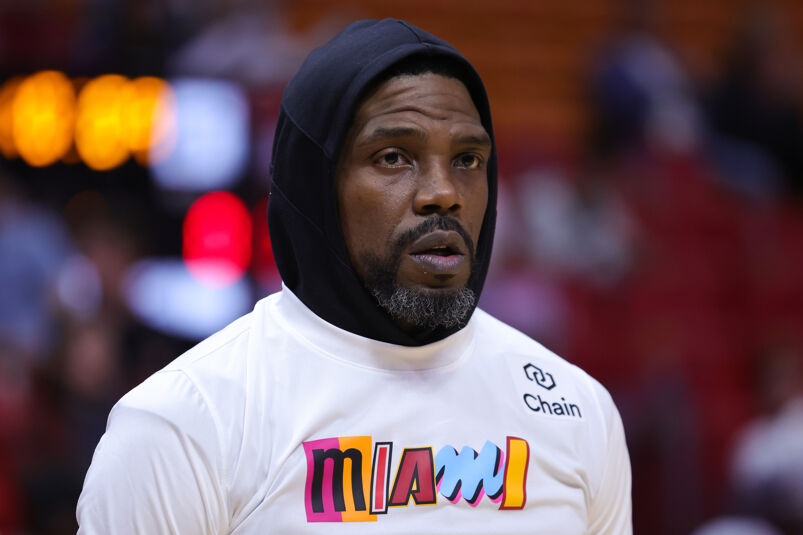 Udonis Haslem wearing a black hooded sweatshirt and a colorful shirt that says "Miami."