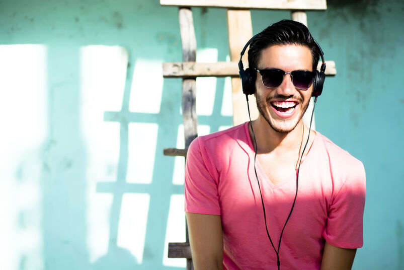 Laughing man wearing headphones