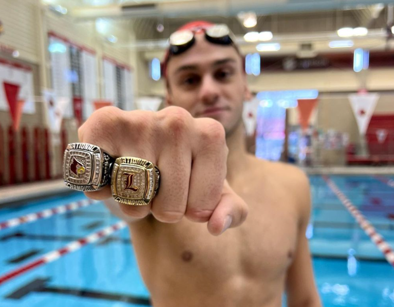 Louisville swimmer Nick Albiero showing off his championship rings.