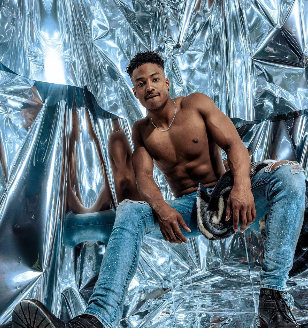 Byron Perkins posing shirtless with jeans.