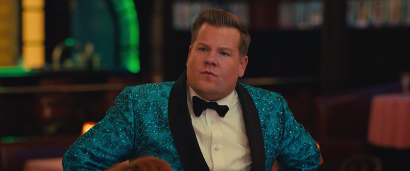James Corden looks puzzled wearing a blue sparkly tuxedo in a scene from 2020's 'The Prom.'