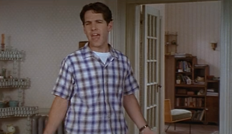 Paul Rudd stands in an apartment, wearing a button-down collared shirt and gesturing flamboyantly in 'The Object of My Affections.'