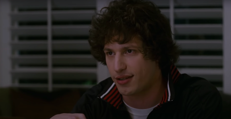Andy Samberg, wearing a sporty gym jacket, looks up from the dinner table annoyed in 'I Love You, Man.'