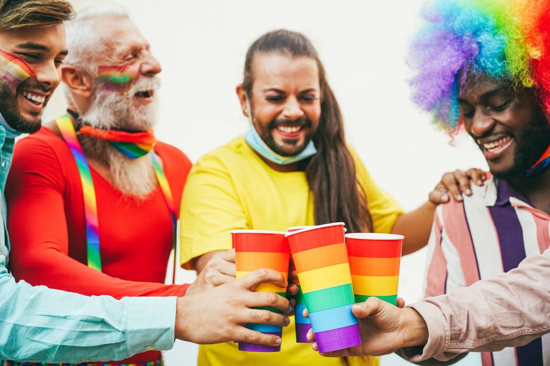 Friends cheering at a Pride event