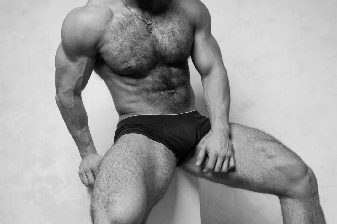 A muscular hairy male body in briefs. 
