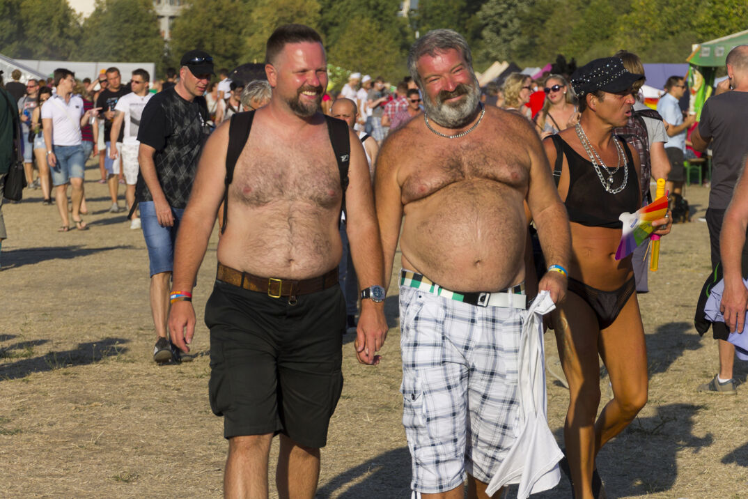 Two shirtless hairy men with beer bellies. 