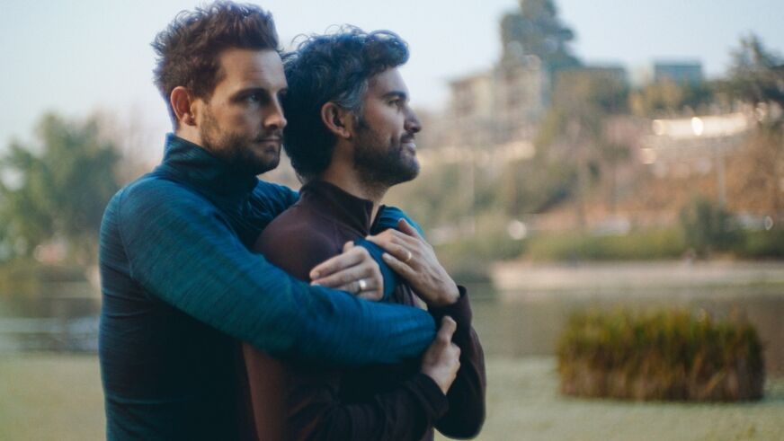 Nico Tortorella and Juan Pablo Di Pace embrace outside in 'The Mattachine Family'