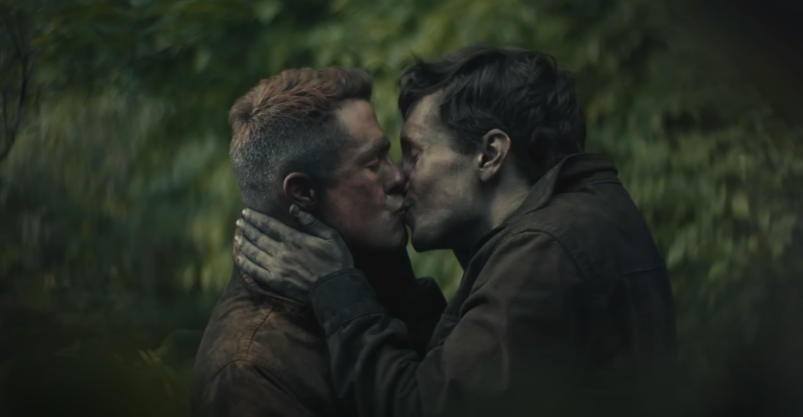 Colton Haynes and James Scully hold each other and kiss, secretly hidden in the forest and wearing coal miner uniforms in Tyler Childers' "In Your Love" music video.
