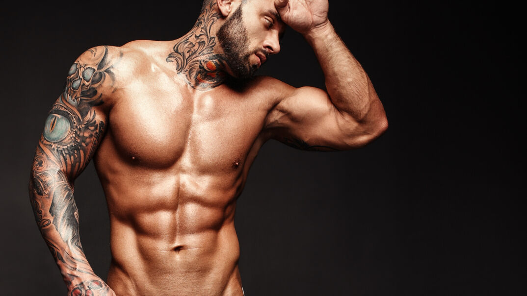 Shirtless, hunky man with tattoos 