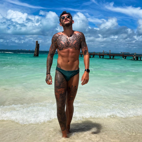 PHOTOS: Champion gymnast Luke Strong and his speedo are heating up beaches around the world