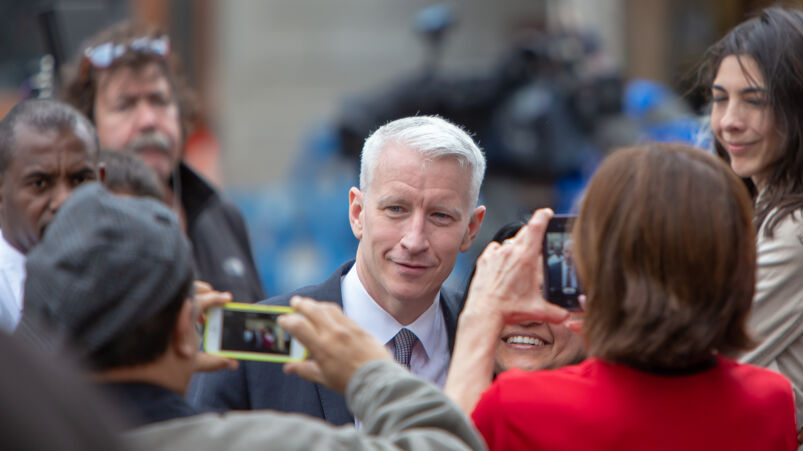 Anderson Cooper is being photographed by the press.