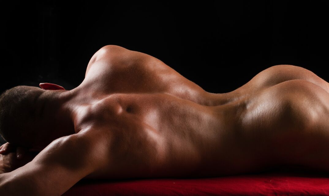A bodybuilder laying down. 