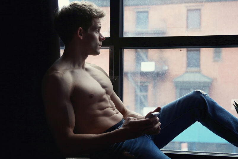 Actor Andrew Keenan-Bolger sits in a window