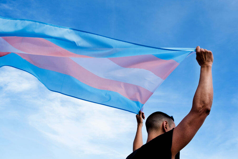 Person waving transgender pride flag