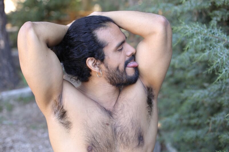 Gay shirtless man licking his own armpit. 
