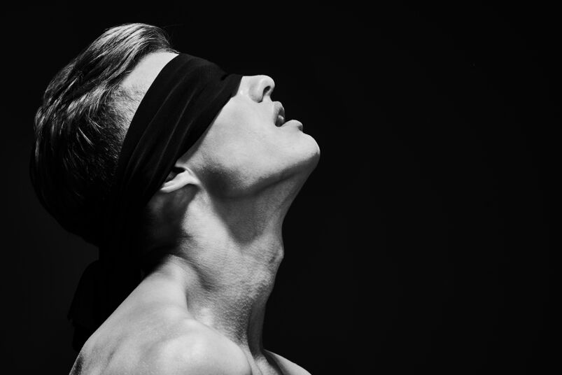 Tricked Into Kissing Another Guy: Art close up portrait of a handsome athletic young white man with a blindfold over his eyes. He has dark hair and is shirtless.  
