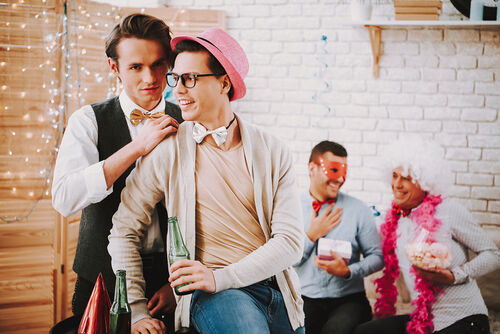 Man flirts with another man in a pink hat