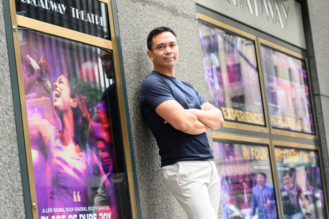 Jose Llana stands in front of the Broadway Theatre.