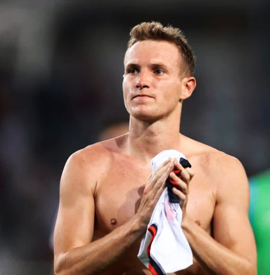 Soccer player Jakub Jankto standing on the field shirtless. 