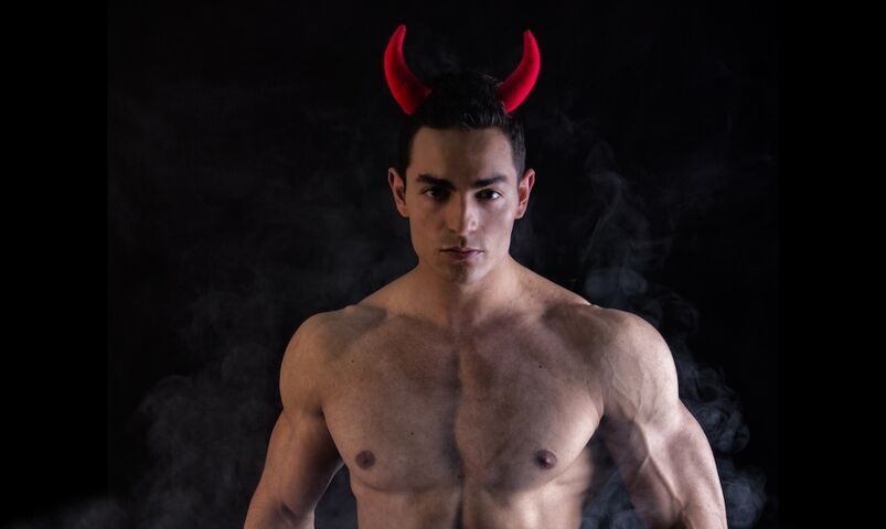 Shirtless man in devil horns, Halloween costume