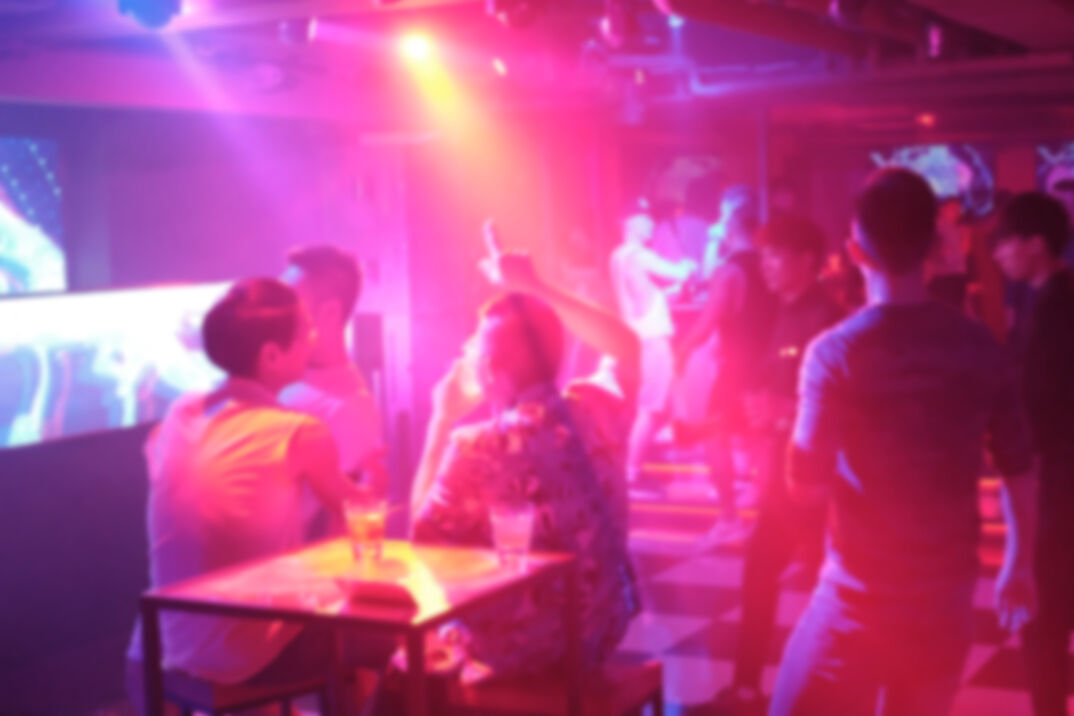 A gay nightclub with a blurry crowd. 
