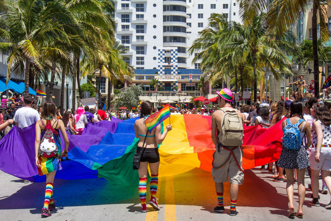 A group carrying the Pride flag in Miami.