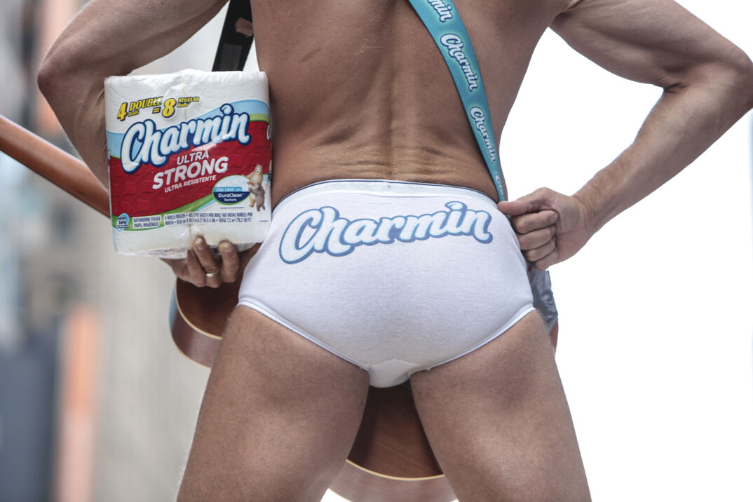 A man wearing tighty whities that say "Charmin" across the back