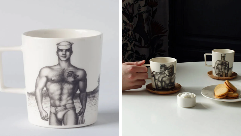 Two panel image. On the left, a white porcelain mug in front of a gray background featuring Tom of Finland artwork with a muscled, shirtless man in a Navy hat and speedo walks on the beach. On the right, the same mug sits on two different coasters in front of a plate of crackers and a side dish of sugar. The mugs rest on a white table in front of a black background. A hand touches the left mug.