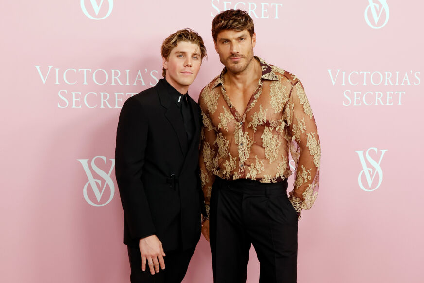 Lukas Gage and Chris Appleton pose at a step-and-repeat for a 'Victoria's Secret' event.