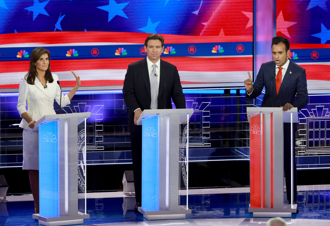 Nikki Haley standing next to Ron DeSantis and Vivek Ramaswamy on the Republican debate stage. 