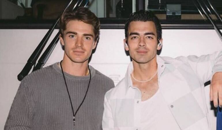 Spencer Neville and Joe Jonas standing side-by-side