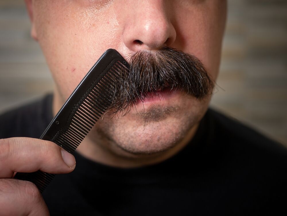 Man combing mustache