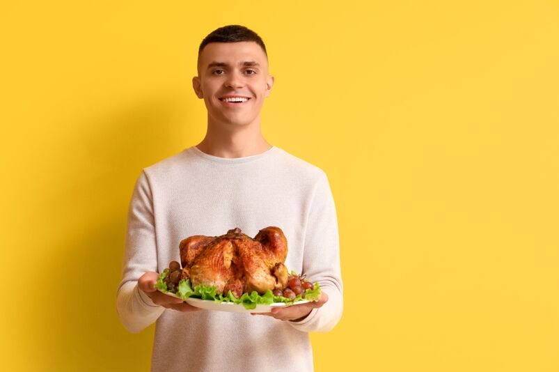 Man holding Thanksgiving turkey