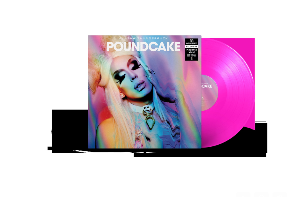 A vinyl album cover is pictured in the middle in front of black graphic designs. The cover features drag queen Alaska, with big blonde space buns and a white necklace, closing her eyes and touching her face. The vinyl reads 'POUNDCAKE' with a rainbow-colored filter distorting the image. Behind it is a magenta-colored vinyl disc.