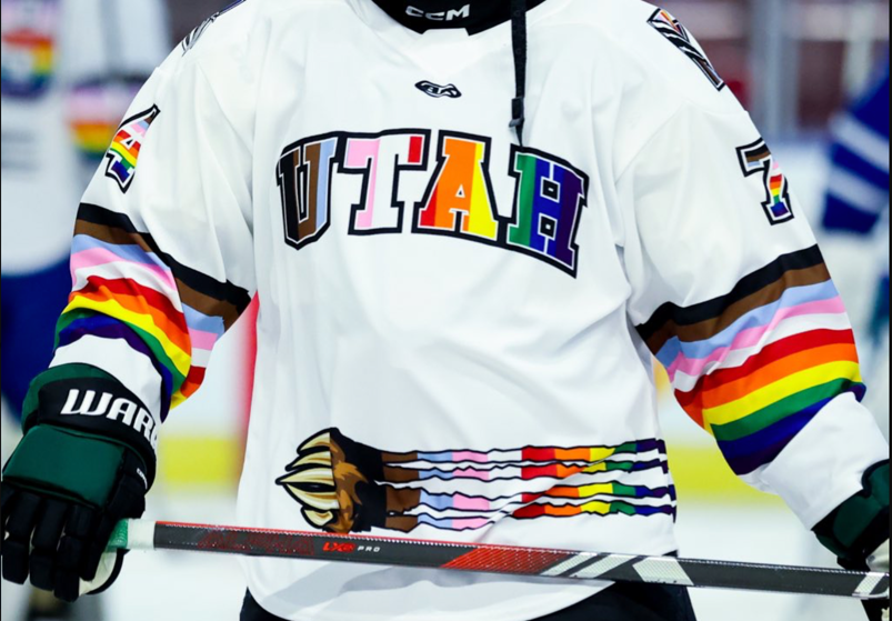 Hockey jersey with "UTAH" written in rainbow lettering with a rainbow grizzly claw. 