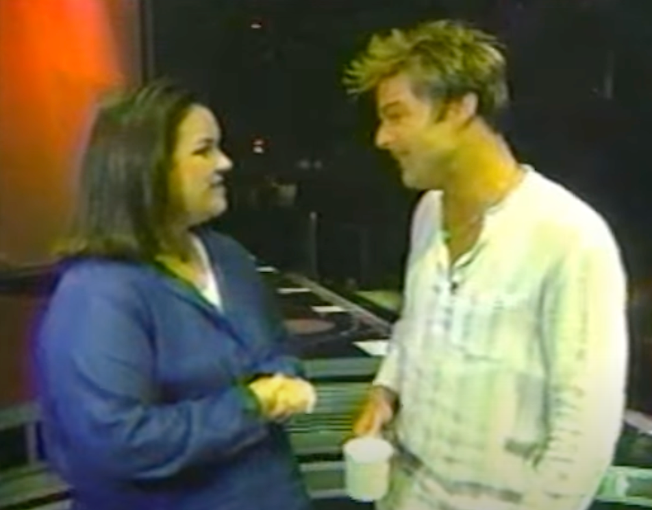 Rosie O'Donnell talking to Ricky Martin backstage at a concert.