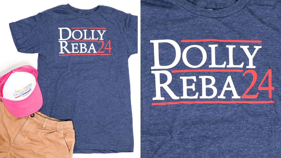 Two-panel image. On the far left, a navy t-shirt reading "Dolly/Reba" in white and "24" in red lays spread open. The text resembles a political advertisement. A pink snapback hat and brown shorts sit on top of the shirts lower left corner for display. On the right, the same shirt but zoomed in to show detail in the text.