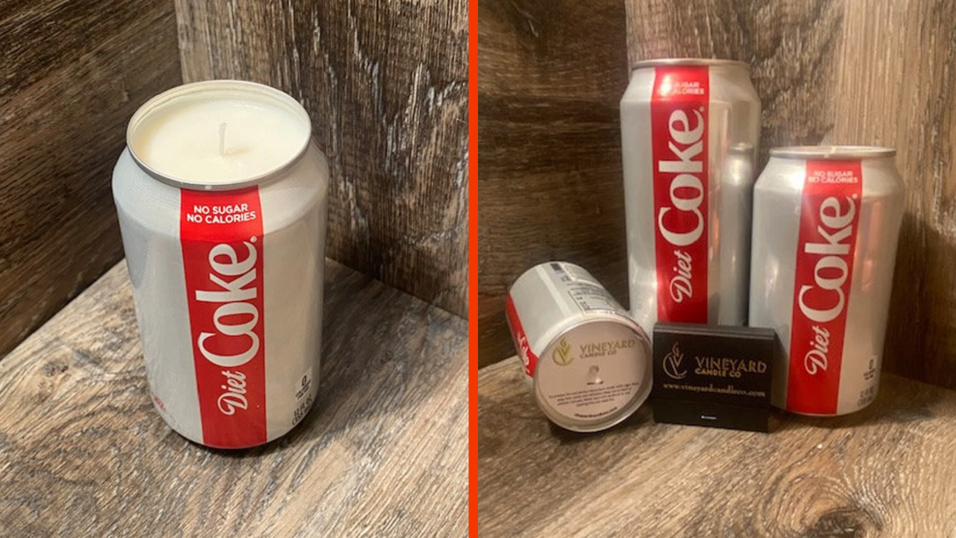Two-panel image. On the left, a Diet Coke can is pictured in a wooden box. The lid is cut off to reveal a white soy wax candle. On the right, the Diet Coke candle is pictured in three sizes (tall, skinny, and regular) in the same wooden box. The far left candle is tipped over to reveal a sticker on its top that reads "Vineyard Candle Co."