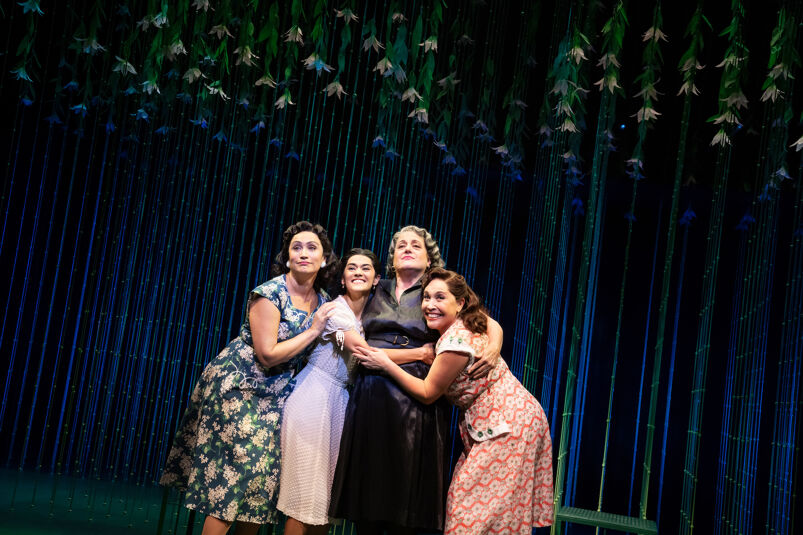 Women huddle in a scene from Off-Broadway's "The Gardens of Anuncia" by Michael John LaChiusa