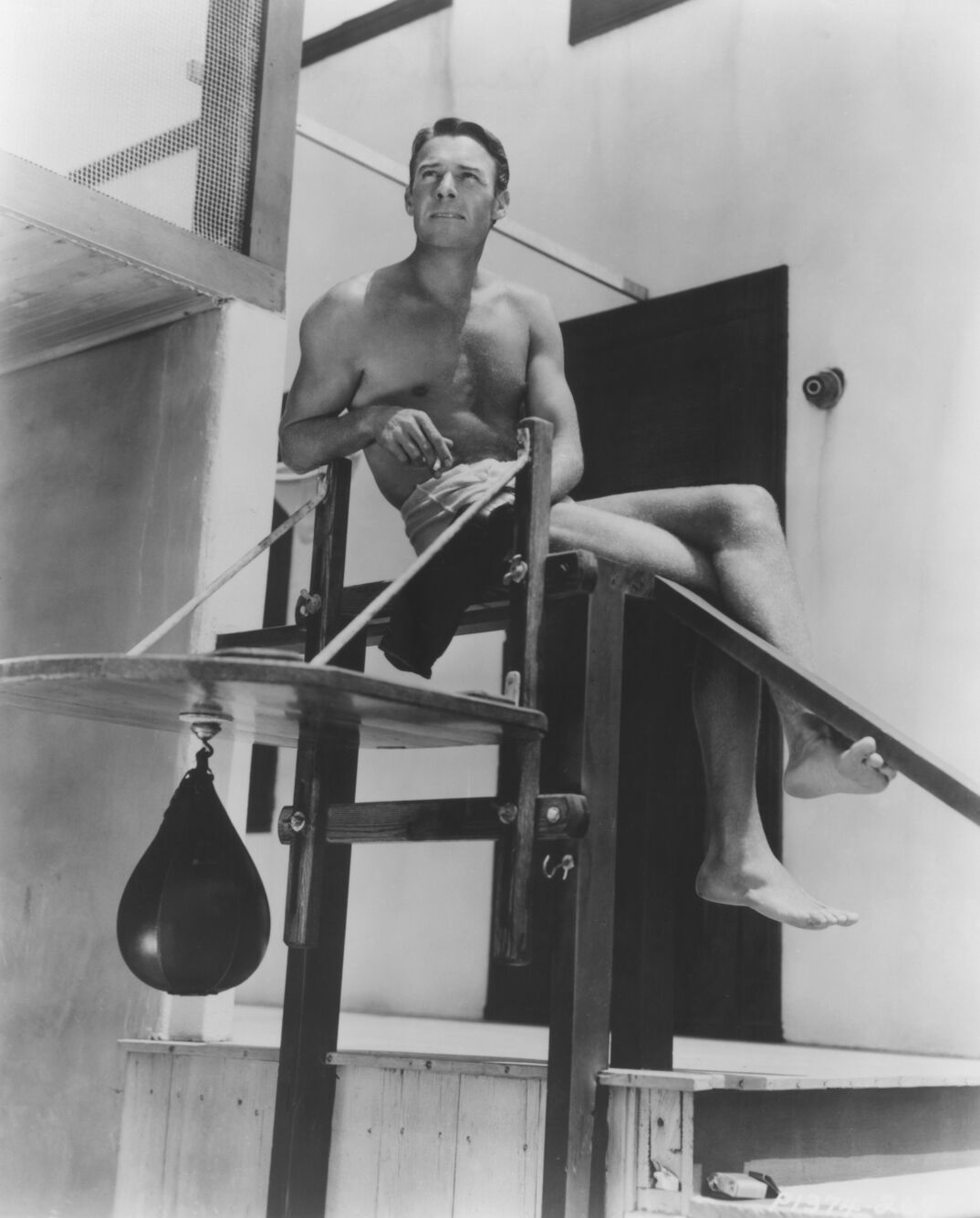 Randolph Scott poses bare-chested on lifeguard tower circa 1940. (Photo by Screen Archives/Getty Images)