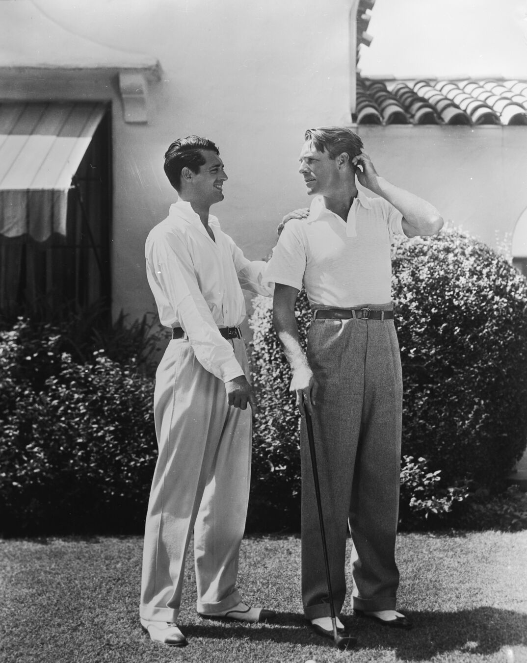 circa 1935:  British born actor Cary Grant (1904 - 1986), born Archibald Leach, with the American actor, Randolph Scott (1898 - 1987). The two stars shared a beach house during the 1930's, which was jokingly known as Bachelor Hall.  (Photo via John Kobal Foundation/Getty Images)
