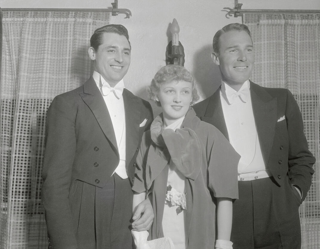 (Original Caption) Mr. and Mrs. Cary Grant (Virginia Cherrill) and Randolph Scott, photographed at the Melody in Spring party given by Ross Saturday evening, on the eve of his departure for New York, from where he will broadcast his next three radio programs.