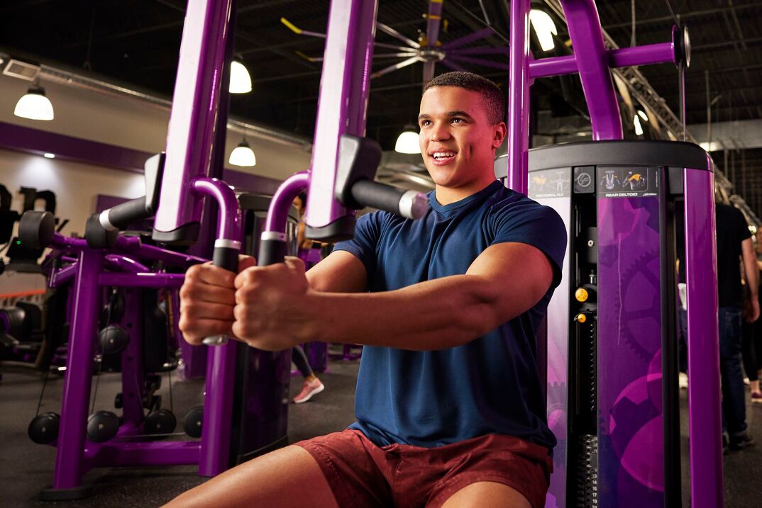 Man working out on chest fly machine at Planet Fitness