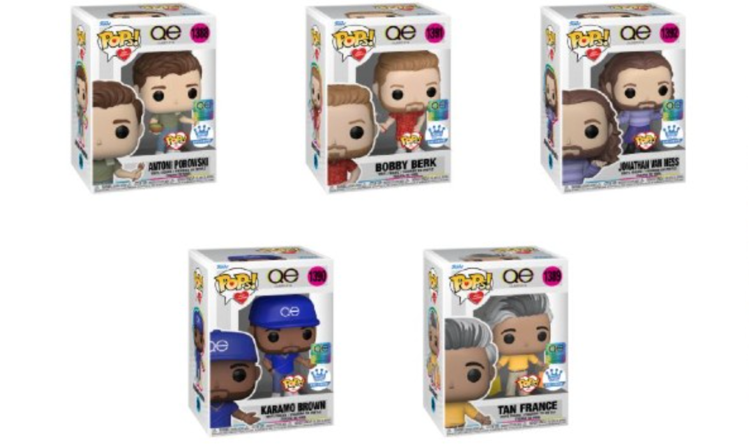 Five display boxes of Funko Pops are arranged on a white background. The cartoonish looking plastic figures are pictured on the box and visible through a display. Each box reads "POP!" and "QE" for "Queer Eye." The figures depict the stars of Netflix's "Queer Eye" as cutesy likenesses about 6 inches tall. Pictured on top row are Antoni Porowski, Bobby Berk, and Jonathan Van Ness. On the bottom are Karamo Brown and Tan France. Each figurine has solid black dots for eyes.