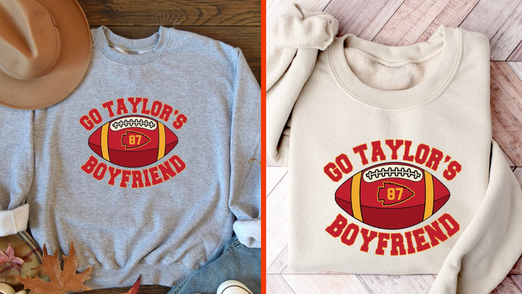 Two-panel image. On the left, a gray crewneck sweater reading "Go Taylor's Boyfriend" in red block letters alongside an illustration of a red football bearing the number "87" in gold. The sweater is pictured next to a tan cowboy hat, autumn leaves, and a Converse shoe. On the right, the same print is pictured on a tan crewneck sweater, displayed on a wooden floor.