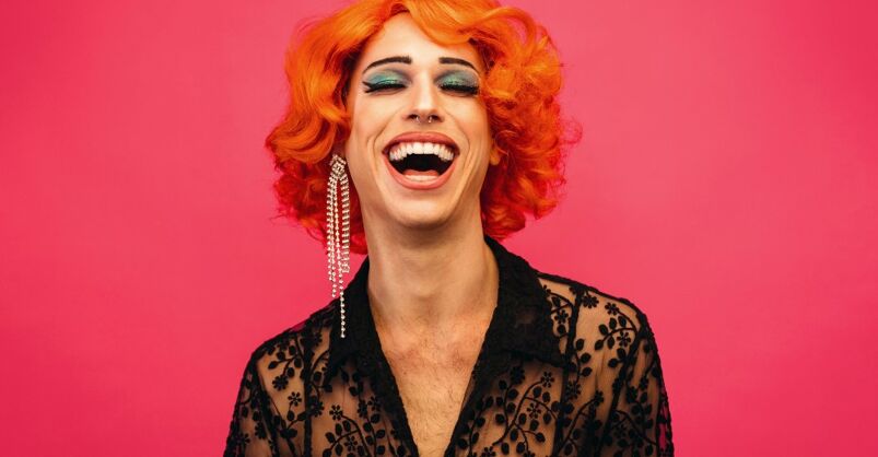 A drag queen laughing