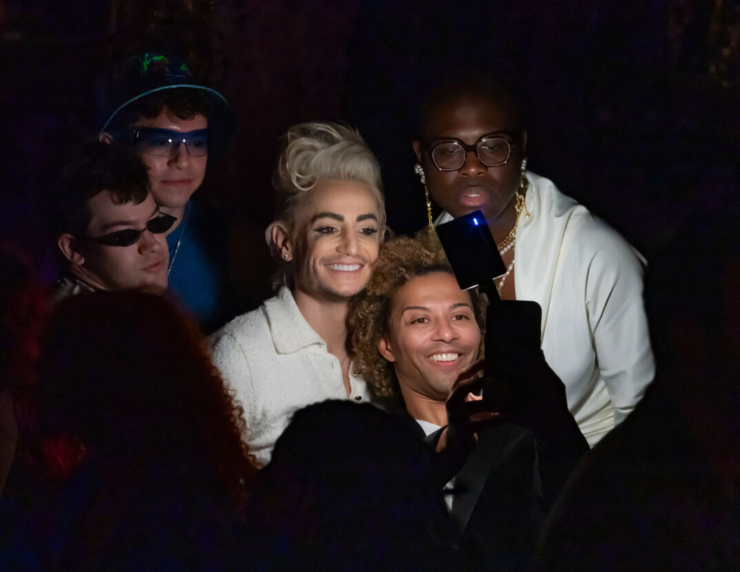 Franke Grande, Shangela, and Bob the Drag Queen smile for a selfie in a dark room at the 2024 Queerties Awards.