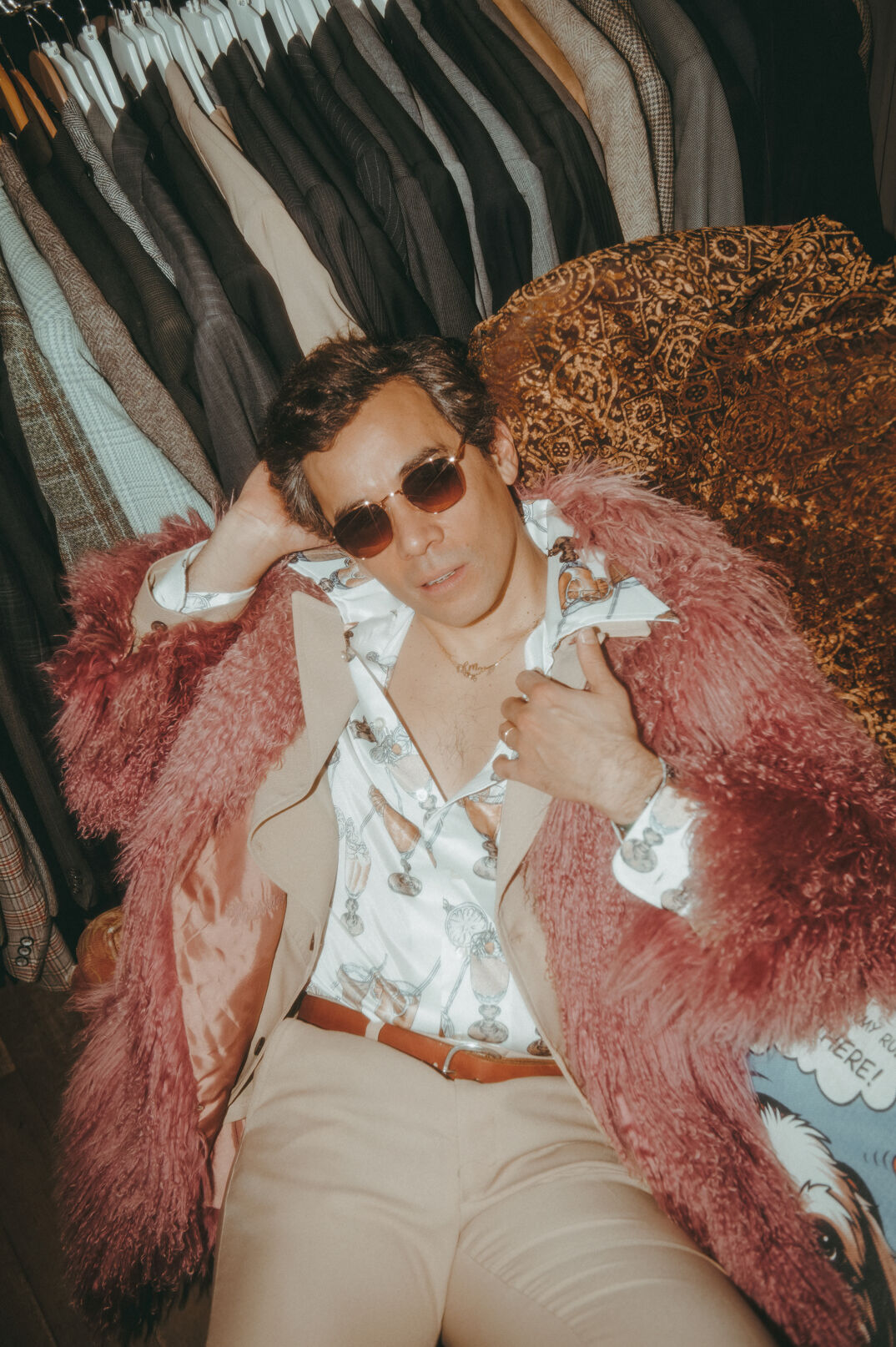 Conrad Ricamora wears sunglasses and a mohair jacket at a NYC vintage store.